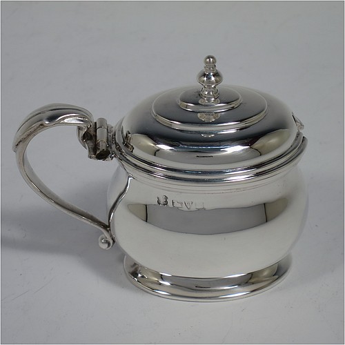 A large and heavy Sterling Silver six-piece condiment service, consisting of two mustard pots with hinged lids, gold-gilt interiors and scroll side-handles, two salt cellars with gold-gilt interiors, two pepper pots with pull-off lids, all with plain oval bellied bodies sitting on collet feet, together with their original condiment spoons, and all fitted into their original cream satin and velvet-lined red presentation box. Made by Edwards and Sons of Chester in 1918. The dimensions of this fine hand-made condiment service are height of pepper pot 11 cms (4.3 inches), length of mustard pot 9 cms (3.5 inches), and with a total weight of approx. 568g (18 troy ounces).
