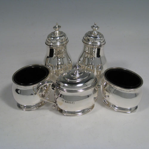 Sterling silver condiment service, consisting of a mustard pot with hinged lid and blue glass liner, two salt cellars with blue glass liners, two pepper pots with pull-off lids, all with plain baluster bodies sitting on collet feet, together with their original condiment spoons, and all fitted into their original satin and velvet-lined presentation box. Made by the Adies Brothers of Birmingham in 1935. Height of pepper pot 10 cms (4 inches), length of mustard pot 9 cms (3.5 inches). Total weight approx. 395g (12.7 troy ounces).