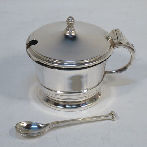 A very elegant Sterling Silver three-piece condiment set in an Art Deco style, consisting of an open salt cellar with a blue glass liner, a pepper pot with pull-off lid, a mustard pot with blue glass liner and hinged lid, together with two original condiment spoons, and all in their cream satin and maroon velvet-lined presentation box. Made by Deakin and Francis of Birmingham in 1970. The dimensions of this fine hand-made silver condiment service are length of mustard pot 7.5 cms (3 inches), height of pepper pot 7 cms (2.75 inches), diameter of salt cellar 6 cms (2.3 inches), and with a total weight of approx. 164g (5.3 troy ounces). 