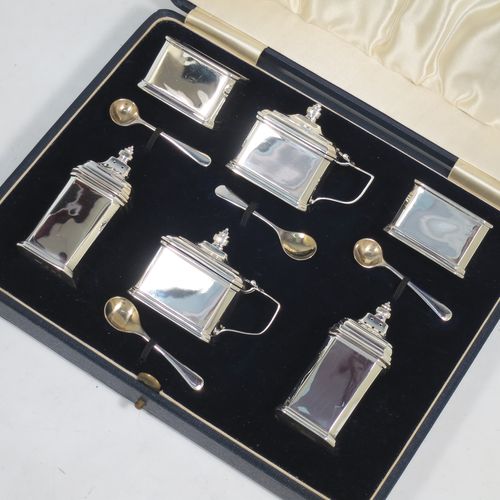 A very handsome Sterling Silver Art Deco six piece condiment service, having octagonal straight-sided bodies, with original blue-glass liners, pull-off lids on the peppers, hinged lids on the mustards, and all in their original dark blue velvet and cream satin-lined presentation box. Consisting of two mustard pots, two pepper pots, two salt cellars, and four condiment spoons. Made by Mappin and Webb of Birmingham in 1928/29. The dimensions of this fine hand-made sterling silver condiment service are height of peppers 7 cms (2.75 inches), length of mustard 6.5 cms (2.5 inches), and a total weight of approx. 190g (6.1 troy ounces). Please note that the silver condiment spoons are made by the Adie Brothers of Birmingham in 1929.   