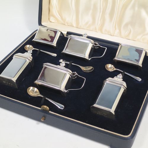 A very handsome Sterling Silver Art Deco six piece condiment service, having octagonal straight-sided bodies, with original blue-glass liners, pull-off lids on the peppers, hinged lids on the mustards, and all in their original dark blue velvet and cream satin-lined presentation box. Consisting of two mustard pots, two pepper pots, two salt cellars, and four condiment spoons. Made by Mappin and Webb of Birmingham in 1928/29. The dimensions of this fine hand-made sterling silver condiment service are height of peppers 7 cms (2.75 inches), length of mustard 6.5 cms (2.5 inches), and a total weight of approx. 190g (6.1 troy ounces). Please note that the silver condiment spoons are made by the Adie Brothers of Birmingham in 1929.   