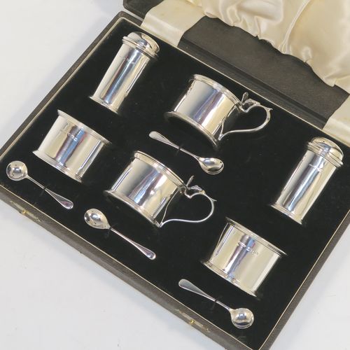 A very handsome Sterling Silver six-piece condiment set, in a very plain round Georgian style with applied reeded borders, and consisting of two pepper pots, two open salt cellars with blue-glass liners, and two covered mustard pots with hinged lids and blue-glass liners, together with two salt spoons and two mustard spoons, and all in their original cream satin and black velvet-lined presentation box. This beautiful silver condiment service was made by S. Blankensee and Sons of Chester and Birmingham in 1939. The dimensions of this fine hand-made silver condiment set are height of pepper pot 7 cms (2.75 inches), length of mustard pot 8 cms (3 inches), and the total weight is approx. 268g (8.6 troy ounces).