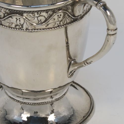 A beautiful Sterling Silver Arts and Crafts style cream or milk jug, having a round body with hand-hammered decoration, with an applied and hand-chased top band of floral work, with a cast rounded side-handle, and all sitting on a spreading round pedestal foot with applied rope-twist borders. This fantastic silver milk or cream jug was made by Harold Edwin Landon of Chester in 1933. The dimensions of this fine hand-made Arts and Crafts jug are height 11.5 cms (4.5 inches), length 14 cms (5.5 inches), and with a weight of approx. 195g (6.3 troy ounces).