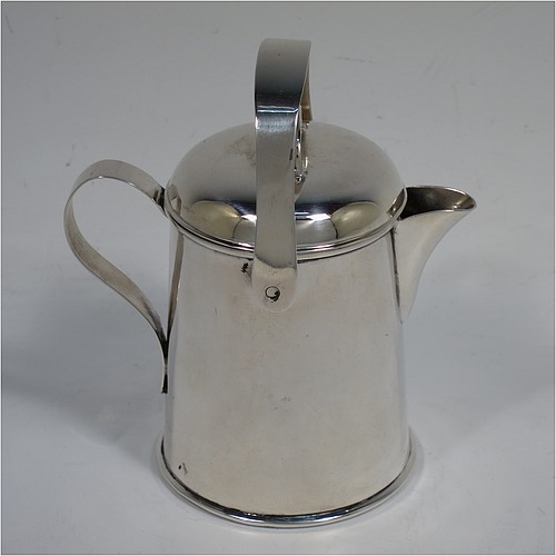 A very unusual Antique Edwardian Sterling Silver cream jug, in a plain watering jug style, with a round straight-sided body, a loop handle and sparrow-beak spout, a lift-off lid with swing-handle, and all sitting on a collet foot. Made by Jones & Crompton of Birmingham in 1902. The dimensions of this fine hand-made antique silver cream jug are height (inc. swing-handle) 10 cms (4 inches), length 9 cms (3.5 inches), and it weighs approx. 93g (3 troy ounces).   