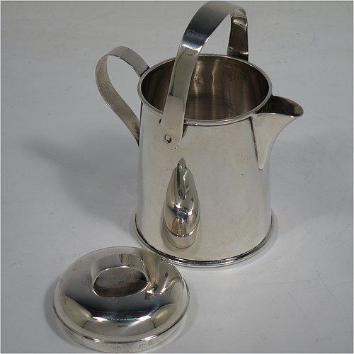 A very unusual Antique Edwardian Sterling Silver cream jug, in a plain watering jug style, with a round straight-sided body, a loop handle and sparrow-beak spout, a lift-off lid with swing-handle, and all sitting on a collet foot. Made by Jones & Crompton of Birmingham in 1902. The dimensions of this fine hand-made antique silver cream jug are height (inc. swing-handle) 10 cms (4 inches), length 9 cms (3.5 inches), and it weighs approx. 93g (3 troy ounces).