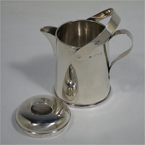 A very unusual Antique Edwardian Sterling Silver cream jug, in a plain watering jug style, with a round straight-sided body, a loop handle and sparrow-beak spout, a lift-off lid with swing-handle, and all sitting on a collet foot. Made by Jones & Crompton of Birmingham in 1902. The dimensions of this fine hand-made antique silver cream jug are height (inc. swing-handle) 10 cms (4 inches), length 9 cms (3.5 inches), and it weighs approx. 93g (3 troy ounces).