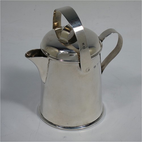 A very unusual Antique Edwardian Sterling Silver cream jug, in a plain watering jug style, with a round straight-sided body, a loop handle and sparrow-beak spout, a lift-off lid with swing-handle, and all sitting on a collet foot. Made by Jones & Crompton of Birmingham in 1902. The dimensions of this fine hand-made antique silver cream jug are height (inc. swing-handle) 10 cms (4 inches), length 9 cms (3.5 inches), and it weighs approx. 93g (3 troy ounces).