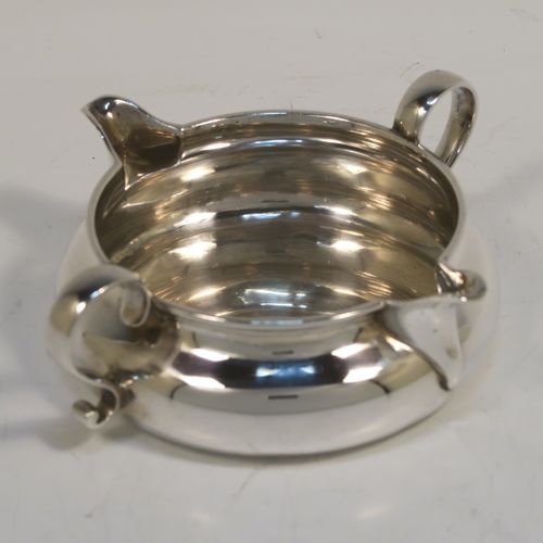 A very unusual and elegant Antique Victorian Sterling Silver double-lipped cream jug, in a sparrow-beak style with a plain round bellied body, with two plain scroll side-handles, two sparrow-beak spouts, and sitting on a flat base. This beautiful cream jug was made by George Fox of London in 1879. The dimensions of this fine hand-made antique silver cream jug are height 4 cms (1.5 inches), diameter of main body 9 cms (3.5 inches), and it weighs approx. 105g (3.4 troy ounces).   