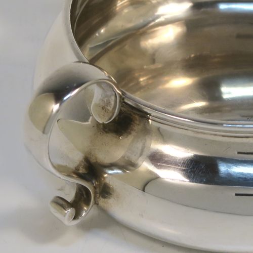 A very unusual and elegant Antique Victorian Sterling Silver double-lipped cream jug, in a sparrow-beak style with a plain round bellied body, with two plain scroll side-handles, two sparrow-beak spouts, and sitting on a flat base. This beautiful cream jug was made by George Fox of London in 1879. The dimensions of this fine hand-made antique silver cream jug are height 4 cms (1.5 inches), diameter of main body 9 cms (3.5 inches), and it weighs approx. 105g (3.4 troy ounces).