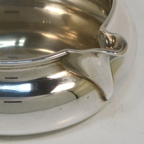 A very unusual and elegant Antique Victorian Sterling Silver double-lipped cream jug, in a sparrow-beak style with a plain round bellied body, with two plain scroll side-handles, two sparrow-beak spouts, and sitting on a flat base. This beautiful cream jug was made by George Fox of London in 1879. The dimensions of this fine hand-made antique silver cream jug are height 4 cms (1.5 inches), diameter of main body 9 cms (3.5 inches), and it weighs approx. 105g (3.4 troy ounces).