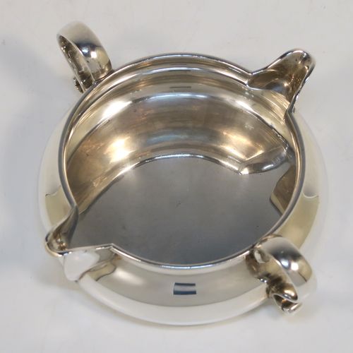 A very unusual and elegant Antique Victorian Sterling Silver double-lipped cream jug, in a sparrow-beak style with a plain round bellied body, with two plain scroll side-handles, two sparrow-beak spouts, and sitting on a flat base. This beautiful cream jug was made by George Fox of London in 1879. The dimensions of this fine hand-made antique silver cream jug are height 4 cms (1.5 inches), diameter of main body 9 cms (3.5 inches), and it weighs approx. 105g (3.4 troy ounces).