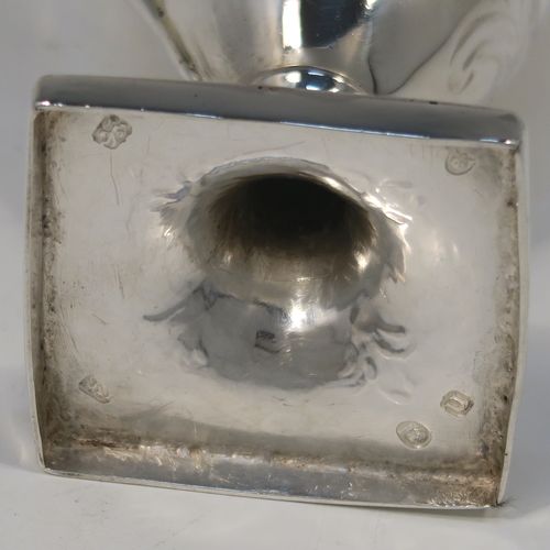 A very pretty Antique Georgian Sterling Silver cream jug, having a round body with tapering sides in a Helmet style, all hand-chased with floral and scroll decoration, a front cartouche with heraldic crest, a scroll handle, and sitting on a pedestal foot with a square base. This beautiful silver cream jug was made by John Denzilow of London in 1788. The dimensions of this fine hand-made antique silver cream jug are length 11.5 cms (4.5 inches), height 15 cms (6 inches), and it weighs approx. 137g (4.4 troy ounces).