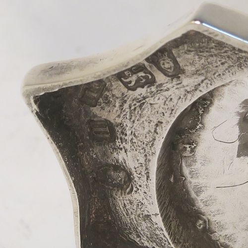 A very handsome Antique Georgian Sterling Silver cream jug, having a plain panelled octagonal body with tapering sides in a Helmet style, a reeded scroll handle and applied top border, and sitting on a pedestal foot with an octagonal shaped base. This beautiful silver cream jug was made by Henry Chawner of London in 1787. The dimensions of this fine hand-made antique silver cream jug are length 13 cms (5 inches), height 14.5 cms (5.75 inches), and it weighs approx. 153g (4.9 troy ounces). Please note that this item is crested.