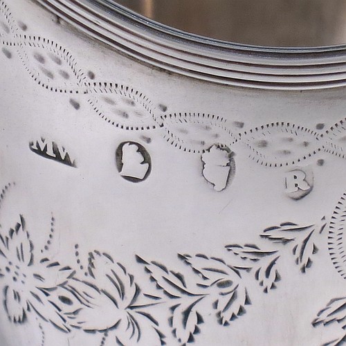 A very pretty Irish Antique Georgian Sterling Silver cream jug, having a round body with tapering sides in a Helmet style, with hand-engraved swags of floral decoration, a vacant oval cartouche, an applied reeded border, a scroll handle, and sitting on a pedestal foot with a round base. Made by Matthew West of Dublin in 1789. The dimensions of this fine hand-made antique Irish silver cream jug are length 11.5 cms (4.5 inches), height 16 cms (6.25 inches), and it weighs approx. 178g (5.7 troy ounces).