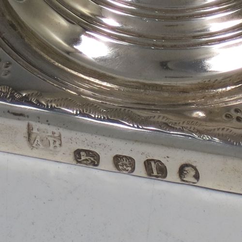 A pretty Antique Georgian Sterling Silver cream jug, having a round body with tapering sides in a Helmet style, with an upper band of floral decoration, a vacant front cartouche, a hand-punched bead border, a scroll handle, and sitting on a pedestal foot with a square base. Made by Peter and Anne Bateman of London in 1792. The dimensions of this fine hand-made antique silver cream jug are length 10 cms (4 inches), height 13 cms (5 inches), and it weighs approx. 84g (2.7 troy ounces).