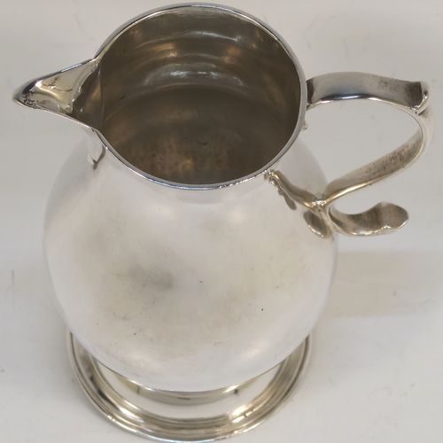 A very handsome Antique Georgian Sterling Silver cream jug, in the sparrow-beak style, having a plain round bellied body, scroll handle, and sitting on a round pedestal foot. This beautiful silver cream jug was made by Henry Brind of London in 1746. The dimensions of this fine hand-made antique silver cream jug are height 10 cms (4 inches), length 8 cms (3 inches), and it weighs approx. 81g (2.6 troy ounces).