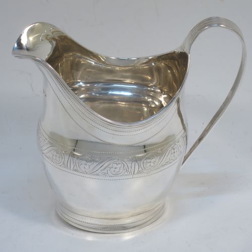 A very elegant Antique Georgian Sterling Silver cream jug, having a round bellied body with hand-chased bands of stipple and floral work, an applied reeded border and reeded scroll handle, and all sitting on a flat base. Made George Burrows of London in 1800. The dimensions of this fine hand-made antique silver cream jug are height 11 cms (4.25 inches), length 11.5 cms (4.5 inches), and it weighs approx. 101g (3.3 troy ounces).
