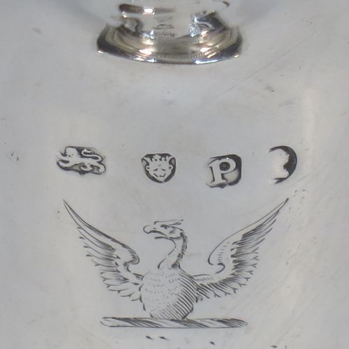 A very elegant Antique Georgian Sterling Silver cream jug, having a round body with tapering sides in a Helmet style, an applied bead-edged border, a reeded scroll handle, and sitting on a pedestal foot with a square base. Made in London in 1790. The dimensions of this fine hand-made antique silver cream jug are length 12 cms (4.75 inches), height 13 cms (5 inches), and it weighs approx. 117g (3.8 troy ounces). Please note that this item is crested.