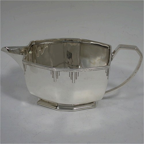 A very handsome Art Deco Sterling Silver cream jug, having a plain panelled rectangular body, a sparrow-beak spout, a cast angular handle, an applied top border with hand-engraved reeding and Deco style decals, and sitting on a collet foot. Made by Emile Viner of Sheffield in 1940. The dimensions of this fine hand-made Art Deco silver cream jug are height 7 cms (2.75 inches), length 15.5 cms (6 inches), width 7.5 cms (3 inches), and it weighs approx. 198g (6.4 troy ounces).