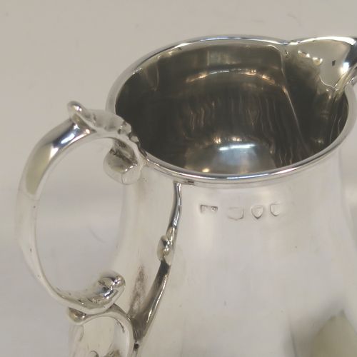 A pretty Antique Victorian Sterling Silver cream jug, in a George I Sparrow-Beak style with a bellied body having hand-chased half-fluted decoration, a plain scroll side-handle, a sparrow-beak spout, and sitting on a collet foot. This beautiful silver cream jug was made by Arthur Sibley of London in 1890. The dimensions of this fine hand-made antique silver cream jug are height 11 cms (4.25 inches), length 9 cms (3.5 inches), and it weighs approx. 121g (3.9 troy ounces).