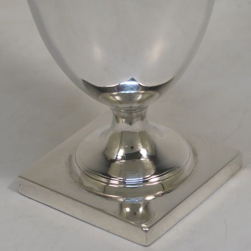 A handsome Antique Georgian Sterling Silver milk or cream jug, having a round body with tapering sides in a Helmet style, with an applied reeded border, a reeded looped handle, and sitting on a pedestal foot with a square base. This elegant antique silver cream or milk jug was made by Stephen Adams I of London in 1794. The dimensions of this fine hand-made antique silver cream jug are length 11 cms (4.3 inches), height 15.5 cms (6 inches), and it weighs approx. 112g (3.6 troy ounces).