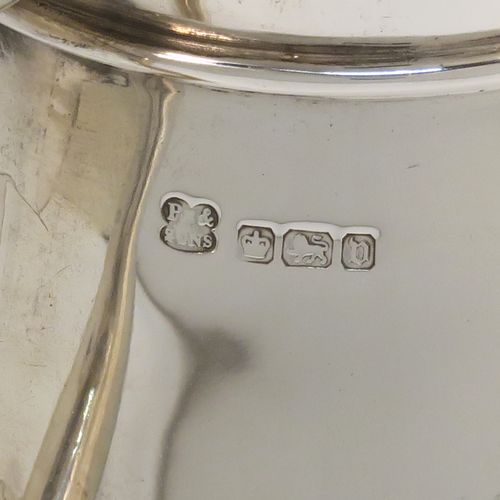 An unusual Arts and Crafts style Antique Sterling Silver cream jug, having a plain round body with tapering sides, an angular side-handle, a sparrow-beak spout, and sitting on a flat base. This beautiful silver cream jug was made by Pearce and Sons of Sheffield in 1913. The dimensions of this fine hand-made antique Arts and Crafts silver cream jug are height 7 cms (2.75 inches), length 13.5 cms (5.25 inches), and it weighs approx. 168g (5.4 troy ounces).