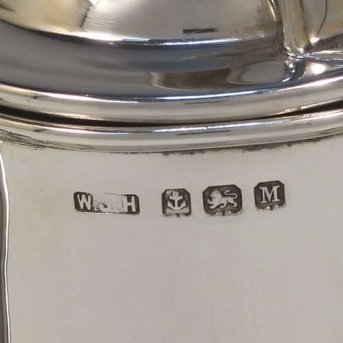 A large and unusual Sterling Silver Guernsey cream or milk jug, having a round bellied body, with a pull-off lid, a sparrow-beak spout, a scroll side-handle, and sitting on a flat base. This handsome silver Guernsey milk jug was made by William Holmes of Birmingham in 1936. The dimensions of this fine hand-made silver milk or cream jug are height 16.5 cms (6.5 inches), length 15.5 cms (6 inches), and it weighs approx. 296g (9.5 troy ounces). Please note that this silver Guernsey milk jug will hold 0.85 litres (1.5 pints).