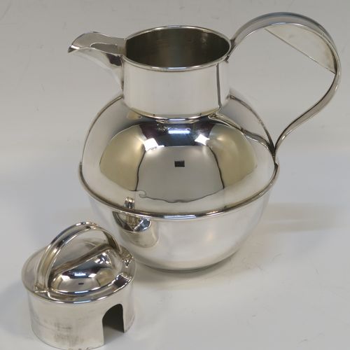 A large and unusual Sterling Silver Guernsey cream or milk jug, having a round bellied body, with a pull-off lid, a sparrow-beak spout, a scroll side-handle, and sitting on a flat base. This handsome silver Guernsey milk jug was made by William Holmes of Birmingham in 1936. The dimensions of this fine hand-made silver milk or cream jug are height 16.5 cms (6.5 inches), length 15.5 cms (6 inches), and it weighs approx. 296g (9.5 troy ounces). Please note that this silver Guernsey milk jug will hold 0.85 litres (1.5 pints).