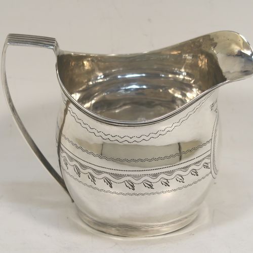 A very pretty Antique Georgian Sterling Silver cream jug, having a round bellied body with hand-engraved bands of stipple and floral work, an applied reeded border and reeded scroll handle, and all sitting on a flat base. This elegant antique silver cream jug was made by Urquart and Hart of London in 1786. The dimensions of this fine hand-made antique silver cream jug are height  cms (3.75 inches), length 11 cms (4.3 inches), and it weighs approx. 78g (2.5 troy ounces).   