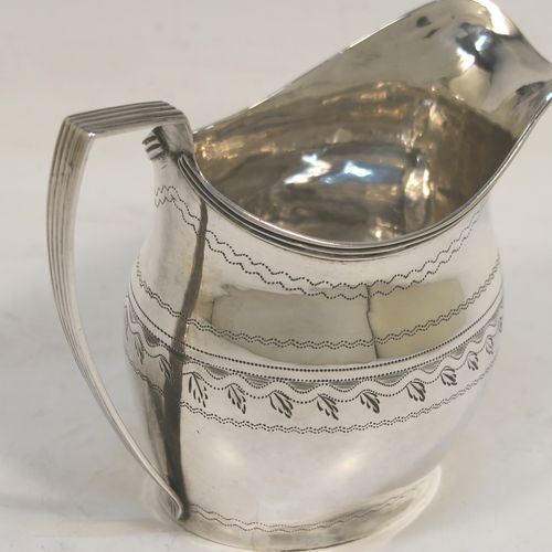 A very pretty Antique Georgian Sterling Silver cream jug, having a round bellied body with hand-engraved bands of stipple and floral work, an applied reeded border and reeded scroll handle, and all sitting on a flat base. This elegant antique silver cream jug was made by Urquart and Hart of London in 1786. The dimensions of this fine hand-made antique silver cream jug are height cms (3.75 inches), length 11 cms (4.3 inches), and it weighs approx. 78g (2.5 troy ounces).