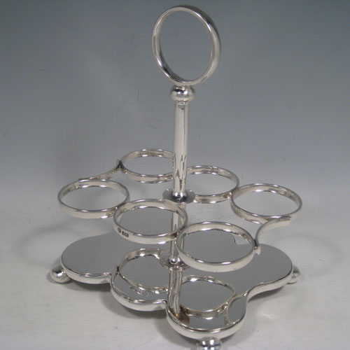Antique Victorian sterling silver cruet set, having a plain stand with ring handle and frame for six hand-cut crystal cruet bottles with original stoppers and silver mounts, all sitting on a base with four cushion feet. Made by William Hutton and Sons of Sheffield in 1901. Height 22 cms (8.75 inches), length 16.5 cms (6.5 inches), width 13 cms (5 inches). Total weight approx. 650g (21 troy ounces).