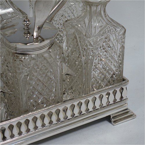 A very pretty Antique Victorian Silver Plated and hand-cut crystal cruet set, having six crystal bottles with original stoppers and silver mounts, sitting in a rectangular hand-pierced gallery frame with reeded borders, on four cast stepped feet. Made by Henry Hobson and Son, of Sheffield in ca. 1890. The dimensions of this fine hand-made antique silver-plated cruet set are height of frame 19 cms (7.5 inches), length 18.5 cms (7.3 inches), and width 14 cms (5.5 inches).
