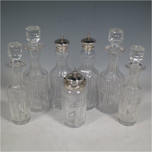 An Antique Victorian Sterling Silver large table cruet set, having a Neoclassical style oval stand with applied bead borders and hand-pierced and engraved decoration, with ring handle and a frame for seven hand-cut crystal cruet bottles with original stoppers and silver mounts, all sitting on a base with four flange feet. Made by James Dixon & Sons of Sheffield in 1872. The dimensions of this fine antique silver cruet set are height 26 cms (10.25 inches), length 20 cms (8 inches), width 16 cms (6.25 inches),and with a total weight of approx. 900g (29 troy ounces).