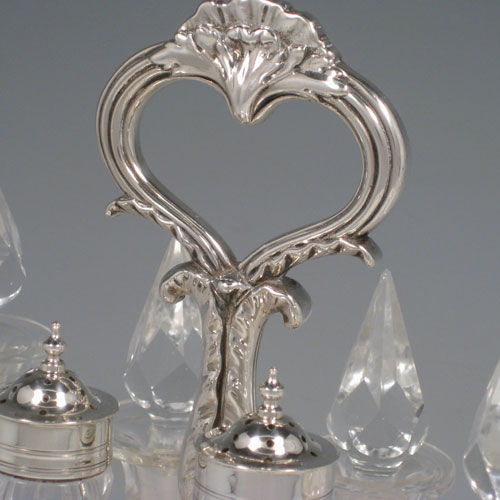 Antique Georgian sterling silver and hand-cut crystal eight-bottle cruet set, made by Robert Hennell II of London in 1833. Please note that the silver lids on the two shaker bottles are not marked. Length 27 cms (10.5