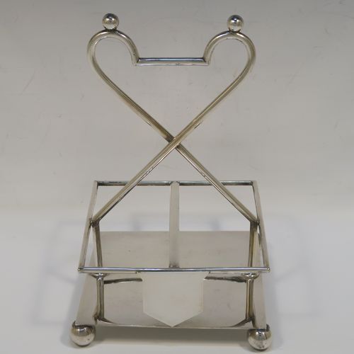 A handsome Antique Victorian Silver Plated and hand-cut crystal cruet set, having four crystal bottles with original stoppers and silver mounts, consisting of an oil and vinegar, a mustard pot spoon, and a pepper shaker, all sitting in a square galleried frame with a wire-work looped handle, and sitting on four cast ball feet. This original antique silver-plated cruet set was ca. 1870. The dimensions of this fine hand-made antique silver-plated cruet set are height of frame 19 cms (7.5 inches), and 11.5 cms (4.5 inches) square.