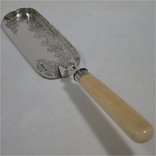 A very pretty Antique Victorian Sterling Silver crumb scoop, having a hand-engraved blade with floral and scroll decoration, and a plain bone handle with reeded ferrule. Made by Martin Hall and Co., of Sheffield in 1897. The dimensions of this fine hand-made antique silver crumb scoop are length 32 cms (12.5 inches), and width of blade 6 cms (2.25 inches).