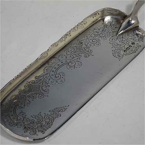 A very pretty Antique Victorian Sterling Silver crumb scoop, having a hand-engraved blade with floral and scroll decoration, and a plain bone handle with reeded ferrule. Made by Martin Hall and Co., of Sheffield in 1897. The dimensions of this fine hand-made antique silver crumb scoop are length 32 cms (12.5 inches), and width of blade 6 cms (2.25 inches).