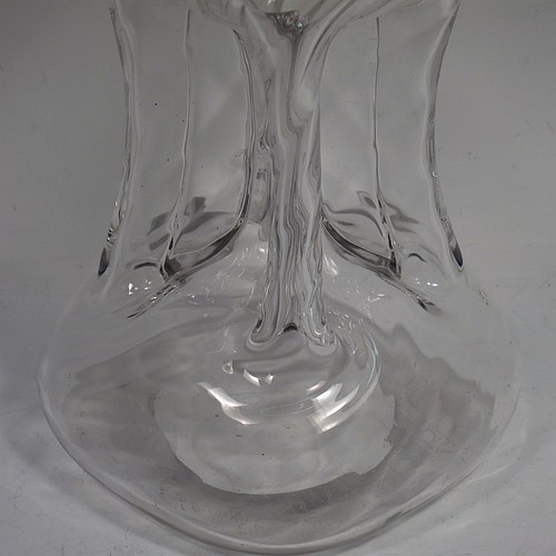 A very pretty Antique Victorian Sterling Silver and cut-crystal glug-glug decanter, having swirl-flute shoulders and clear bottom body, with four pinched and fluted central waists between, a plain round neck mount with four pouring spouts, and a hand-cut spherical crystal stopper. Made by Henry Miller of Birmingham in 1898. The dimensions of this fine hand-made antique silver and crystal glug glug decanter are height 28 cms (11 inches), and width at base 11.5 cms (4.5 inches).   