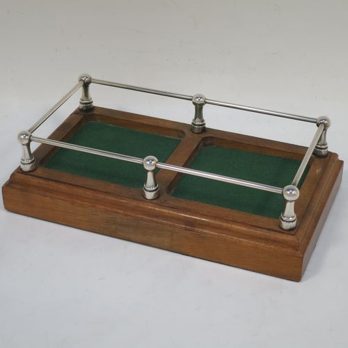 A very handsome pair of small Sterling Silver and hand-cut crystal decanters sitting in a galleried wood base, having square cross-section bodies with silver collars and original stoppers, all sitting in a silver galleried wooden base with green felt interiors. Made by Charles S. Green and Co. Ltd., of Birmingham in 1986. The dimensions of this fine pair of silver and crystal decanters (including base) are height 17 cms (6.75 inches), length 19 cms (7.5 inches), and width 10 cms (4 inches).