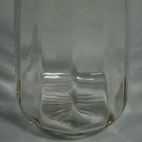 A pair of Antique Sterling Silver and cut-crystal decanters, having plain panelled bodies, plain round silver necks, with original hand-cut lobed stoppers, and all sitting on star-cut flat bases. Made by William Hutton and Sons Ltd., of Birmingham in 1912. The dimensions of this fine pair of antique silver and crystal decanters are height 27 cms (10.75 inches), and diameter at bases 10 cms (4 inches).