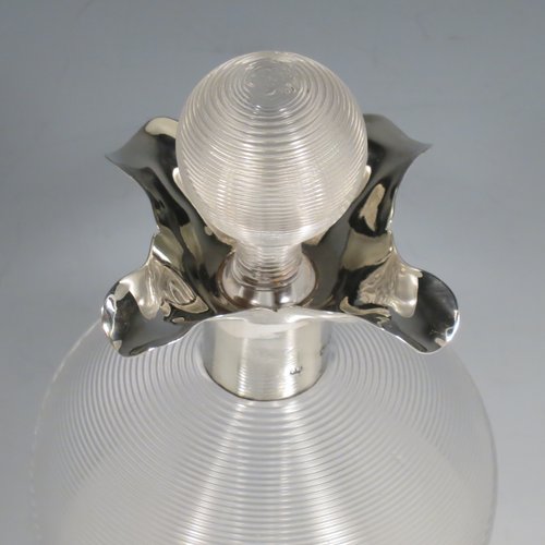 An Antique Victorian large Sterling Silver and cut-crystal glug-glug decanter, having a ribbed body with pinched and fluted central waists, plain round necks with four pouring spouts, and original hand-cut stopper. Made by John N. Mappin of London in 1893. The dimensions of this fine hand-made silver and crystal glug glug decanter are height 29 cms (11.5 inches), and width 13 cms (5 inches).