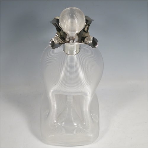 An Antique Victorian large Sterling Silver and cut-crystal glug-glug decanter, having a ribbed body with pinched and fluted central waists, plain round necks with four pouring spouts, and original hand-cut stopper. Made by John N. Mappin of London in 1893. The dimensions of this fine hand-made silver and crystal glug glug decanter are height 29 cms (11.5 inches), and width 13 cms (5 inches).