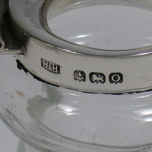 A very handsome pair of Antique Sterling Silver and crystal whisky toddies or noggins, having round hand-cut crystal bodies with tapering sides and loop handles, mounted with silver collars and hinged flat lids with thumb-pieces, all sitting on flat star-cut bases. Made by Hukin and Heath of Birmingham in 1913. The dimensions of this fine hand-made pair of antique silver and crystal noggins or toddies are height 10 cms (4 inches), and diameter at bases 6.5 cms (2.5 inches).