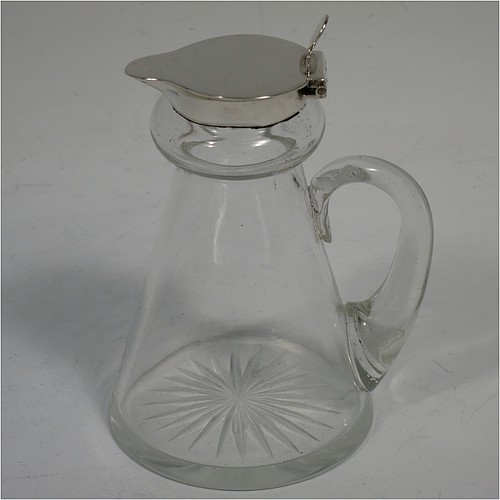 A very handsome pair of Antique Sterling Silver and crystal whisky toddies or noggins, having round hand-cut crystal bodies with tapering sides and loop handles, mounted with silver collars and hinged flat lids with thumb-pieces, all sitting on flat star-cut bases. Made by Hukin and Heath of Birmingham in 1913. The dimensions of this fine hand-made pair of antique silver and crystal noggins or toddies are height 10 cms (4 inches), and diameter at bases 6.5 cms (2.5 inches).