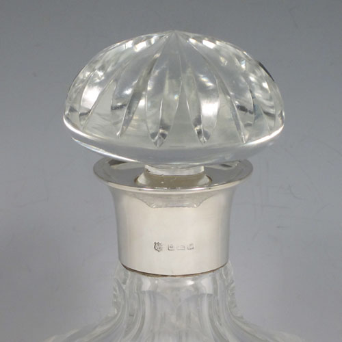 Sterling silver and hand-cut crystal decanter, having a square cross-section body with tapering sides, hand-cut fluted decoration, a silver collar with lip, and original fluted stopper. Made by Barker Brothers Ltd., of Birmingham in 1939. The dimensions of this fine silver and crystal decanter are height 23 cms (9 inches), and width 10 cms (4 inches).