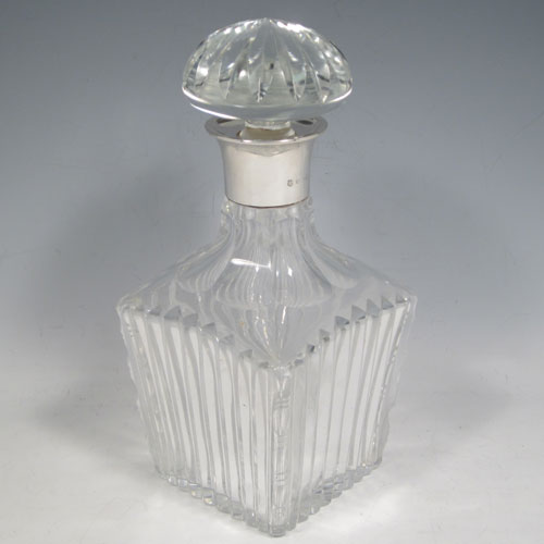 Sterling silver and hand-cut crystal decanter, having a square cross-section body with tapering sides, hand-cut fluted decoration, a silver collar with lip, and original fluted stopper. Made by Barker Brothers Ltd., of Birmingham in 1939. The dimensions of this fine silver and crystal decanter are height 23 cms (9 inches), and width 10 cms (4 inches).