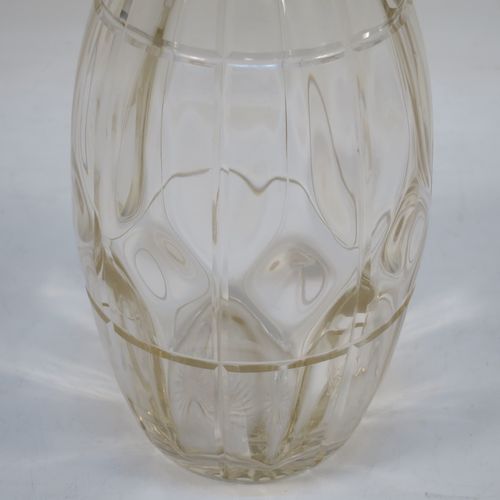 A very unusually designed Sterling Silver and hand-cut crystal decanter, having an oval body , and with hand-cut reeded decoration together with internal lobed work, a plain silver collar, an original hand-cut stopper, and sitting on a flat base with a star-cut. Made by John Grinsell of Birmingham in 1910. The dimensions of this fine hand-made silver and crystal decanter are height 25.5 cms (10 inches), and diameter 10 cms (4 inches).