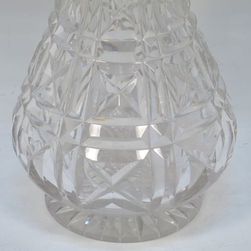 A very handsome Antique Sterling Silver and hand-cut crystal decanter, having a tear-drop shaped body with tapering sides, with hand-cut geometrical decoration, a silver collar and lip, and with original stopper. This elegant silver and crystal decanter was made by R. F. Mosley and Co., of of Sheffield in 1922. The dimensions of this fine hand-made antique silver and crystal decanter are height 32.5 cms (12.75 inches), and diameter at base 11.5 cms (4.5 inches).