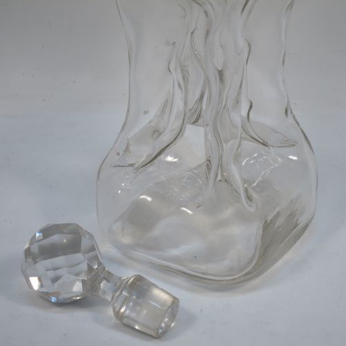 A very pretty Antique Edwardian Sterling Silver and cut-crystal glug-glug decanter, having swirl-flute shoulders and clear bottom body, with four pinched and fluted central waists between, a plain round neck mount, and a hand-cut spherical and faceted crystal stopper. Made in Birmingham in 1909. The dimensions of this fine hand-made antique silver and crystal glug glug decanter are height 28.5 cms (11.25 inches), and width at base 11.5 cms (4.5 inches).