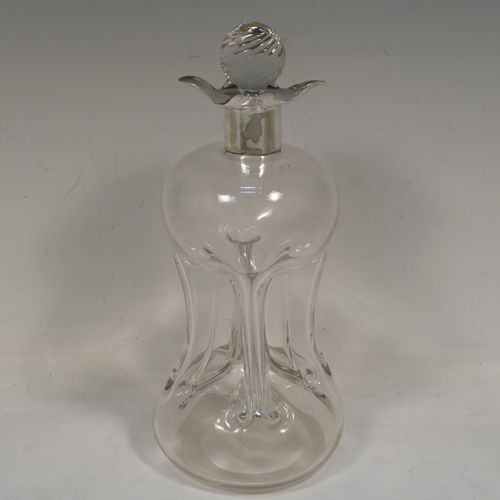A very pretty Antique Victorian Sterling Silver and hand-cut crystal glug-glug decanter, having a plain body with four pinched and fluted central waists between, a plain round neck mount with four spouts, and a swirl fluted crystal stopper. This beautiful antique silver and crystal decanter was made by William Hammon of Chester in 1895. The dimensions of this fine hand-made antique silver and crystal glug glug decanter are height 21.5 cms (8.5 inches), and width at base 9 cms (3.5 inches).